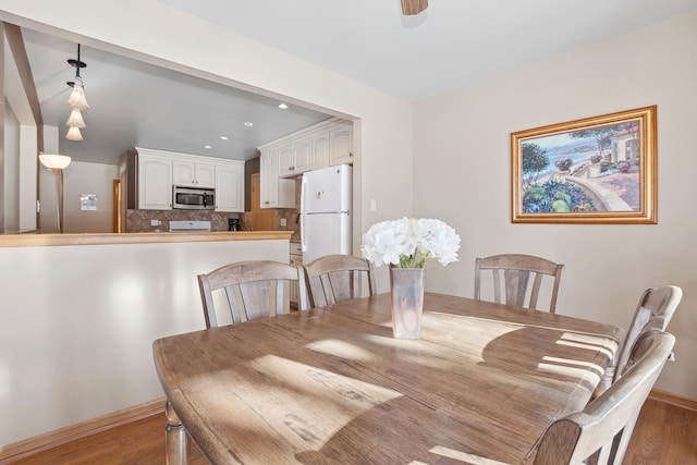 dining room featuring ceiling fan and light wood-type flooring