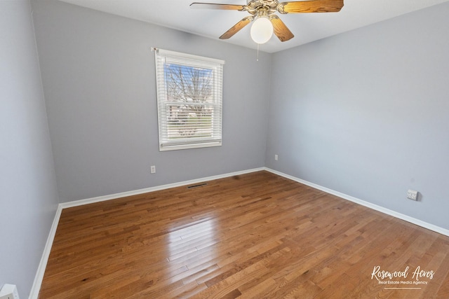 empty room with ceiling fan and wood-type flooring