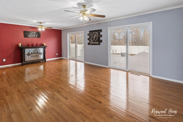 unfurnished living room with ceiling fan, plenty of natural light, ornamental molding, and hardwood / wood-style flooring