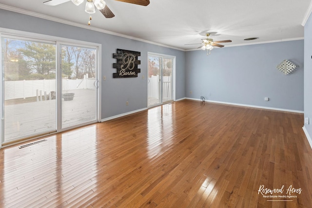 spare room with ceiling fan, wood-type flooring, and crown molding