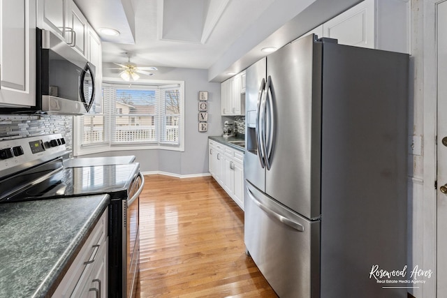 kitchen with backsplash, ceiling fan, light hardwood / wood-style floors, white cabinetry, and stainless steel appliances