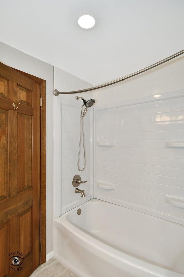 bathroom with tile patterned flooring and tiled shower / bath