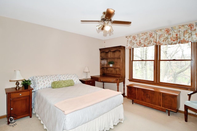 bedroom with light carpet and ceiling fan