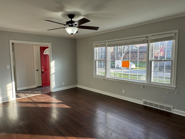 unfurnished room featuring ornamental molding, ceiling fan, and dark wood-type flooring