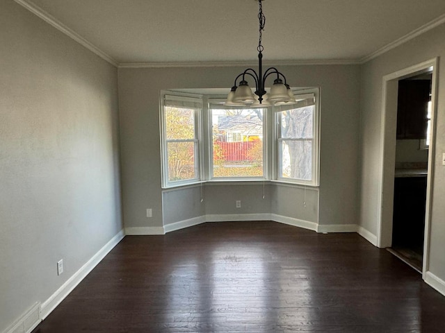 unfurnished dining area featuring a chandelier, dark hardwood / wood-style flooring, and crown molding