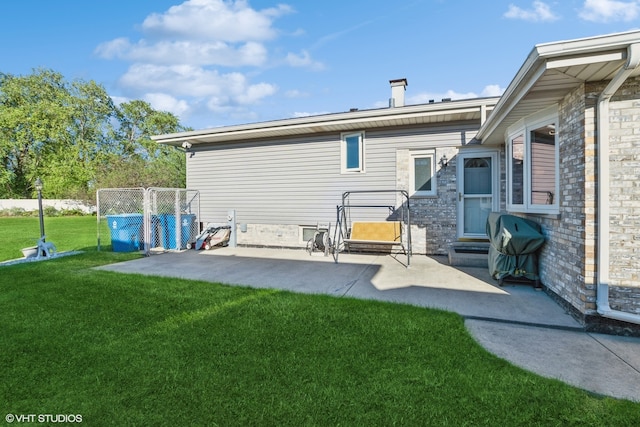 back of house featuring a yard and a patio area