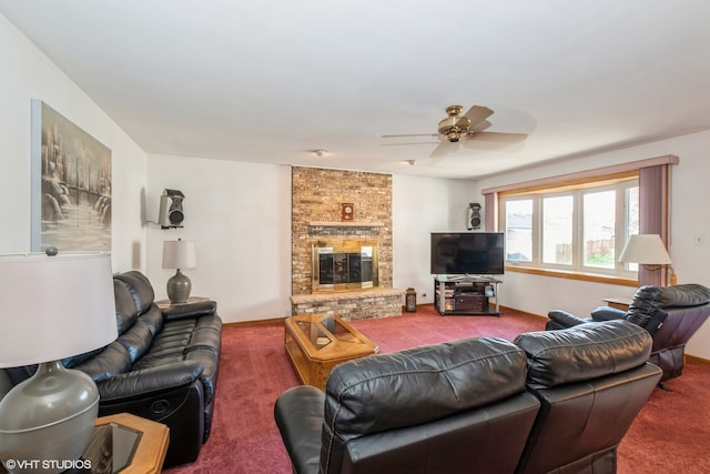 living room featuring carpet flooring, ceiling fan, and a large fireplace