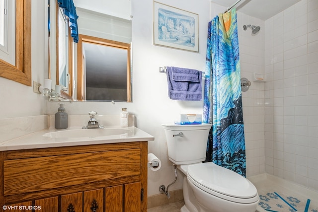 bathroom featuring vanity, toilet, and curtained shower