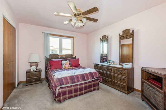 carpeted bedroom with ceiling fan and a closet