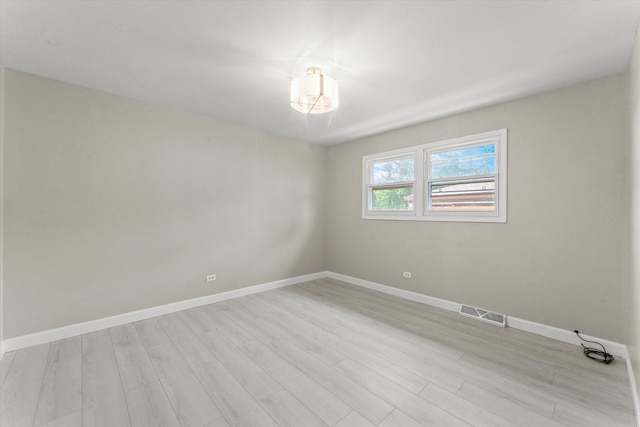 spare room featuring light hardwood / wood-style floors