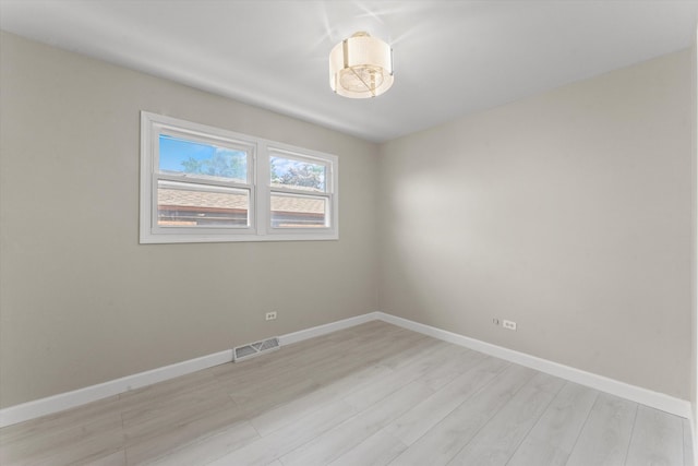 spare room featuring light hardwood / wood-style flooring