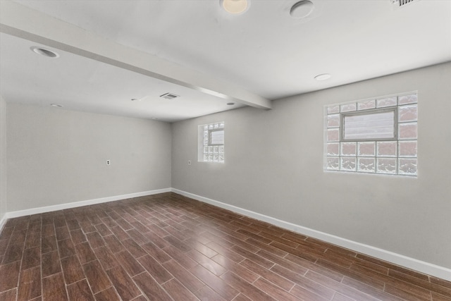 basement with dark hardwood / wood-style flooring