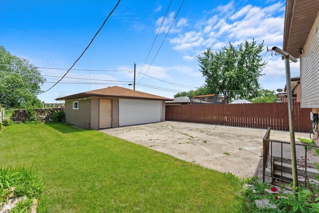 view of yard featuring an outbuilding, a patio, and a garage