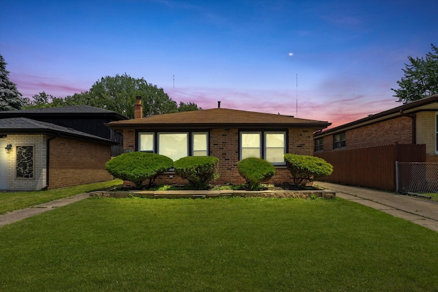 view of front of house with a yard