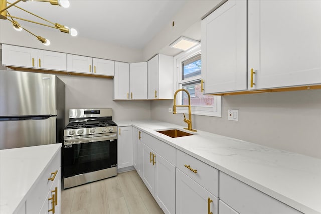 kitchen featuring light hardwood / wood-style flooring, stainless steel appliances, white cabinetry, and sink