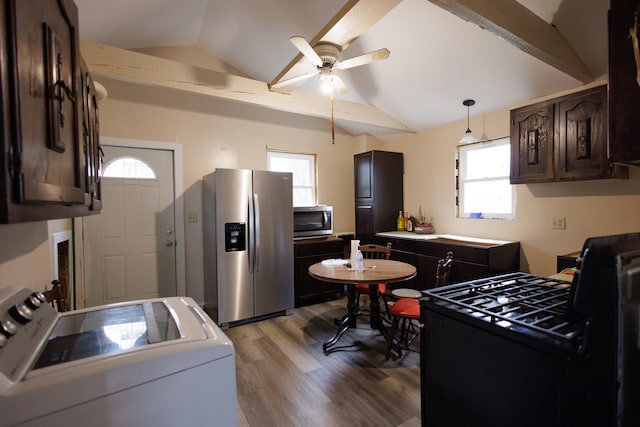 kitchen featuring appliances with stainless steel finishes, washer / clothes dryer, and plenty of natural light