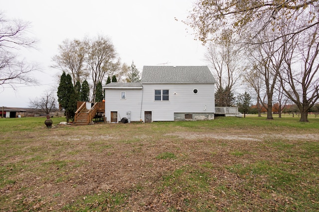 back of house featuring a yard and a deck