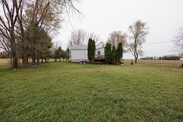 view of yard with a rural view and a deck