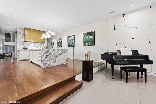 living area featuring recessed lighting, visible vents, and a chandelier