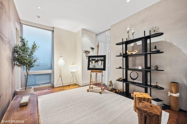 living area with recessed lighting and wood finished floors