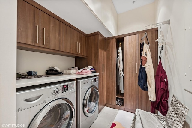 clothes washing area with cabinet space and washing machine and dryer