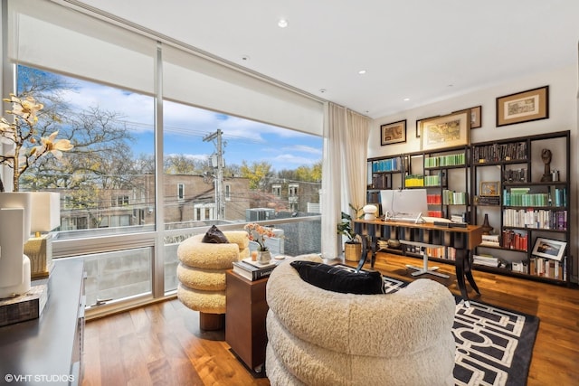 sitting room with recessed lighting, expansive windows, and wood finished floors