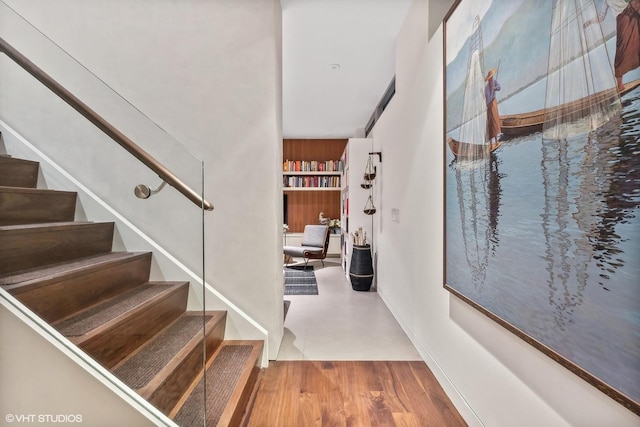 stairs featuring wood finished floors