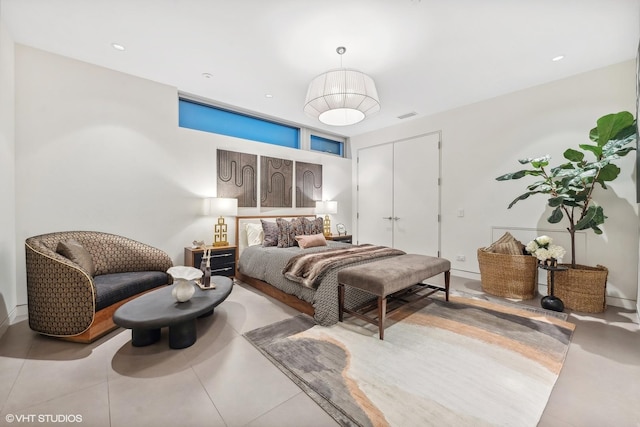 bedroom with a closet, visible vents, and recessed lighting