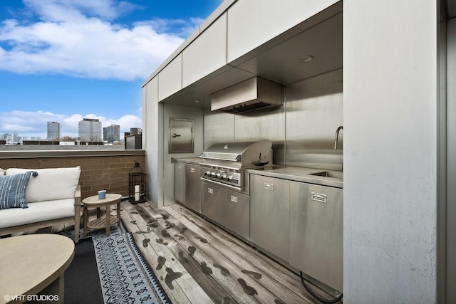 view of patio / terrace featuring area for grilling, a view of city, and a grill