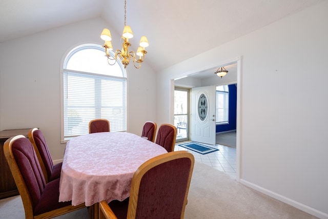 dining space featuring a notable chandelier, light colored carpet, and lofted ceiling