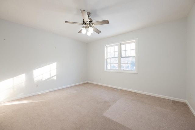 carpeted empty room featuring ceiling fan