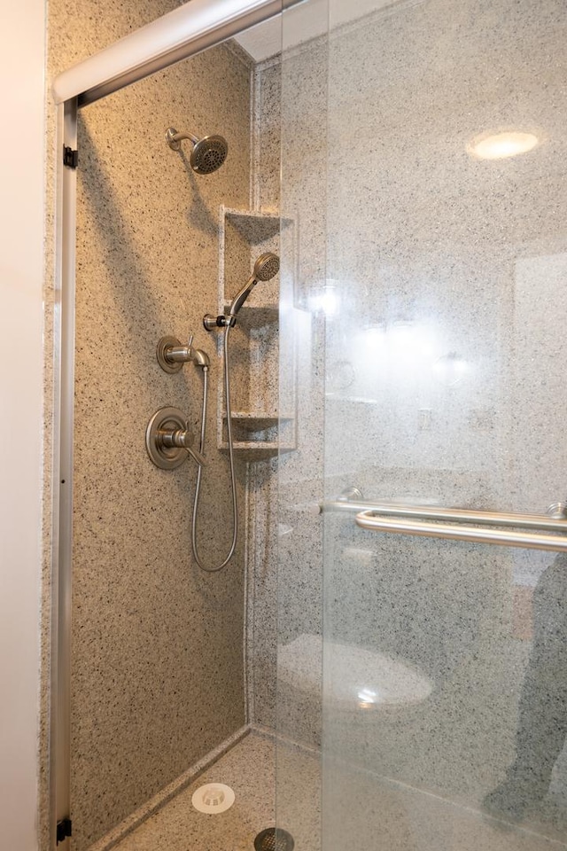 bathroom featuring a shower with shower door