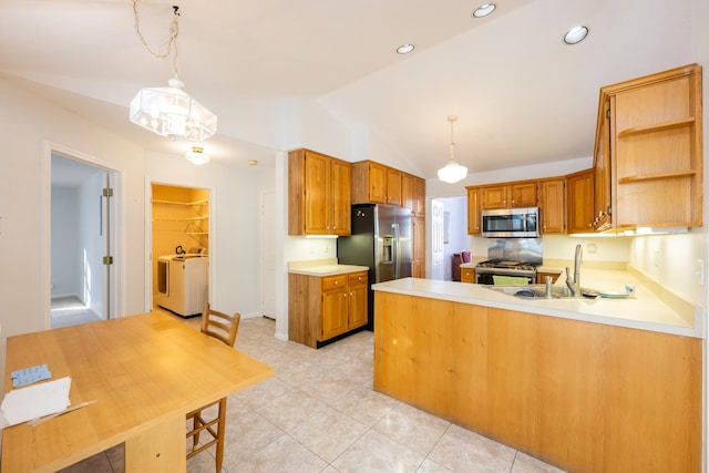 kitchen featuring kitchen peninsula, hanging light fixtures, appliances with stainless steel finishes, and lofted ceiling