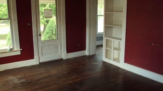 interior space with a healthy amount of sunlight and dark hardwood / wood-style floors