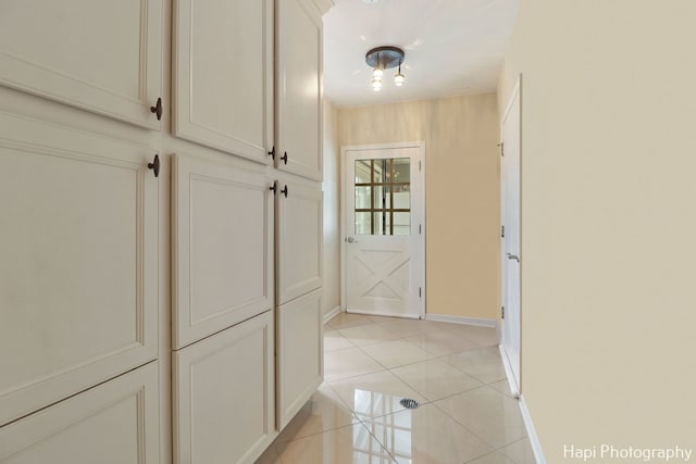 corridor with light tile patterned floors