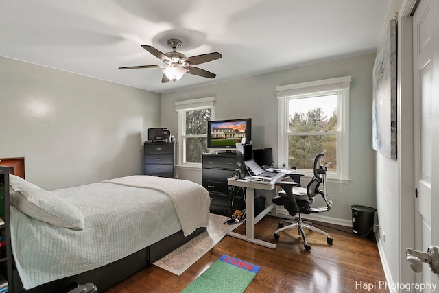 bedroom with dark wood-type flooring and ceiling fan