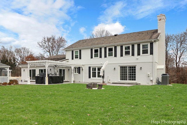 back of house featuring a yard, a pergola, and a patio