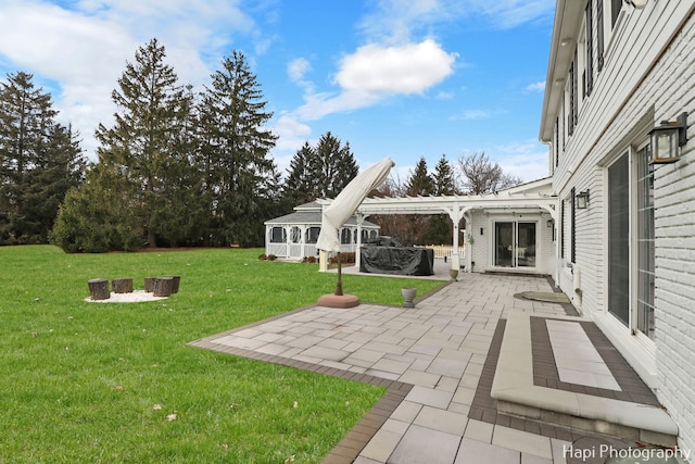 view of yard featuring a pergola, a patio area, and an outdoor fire pit