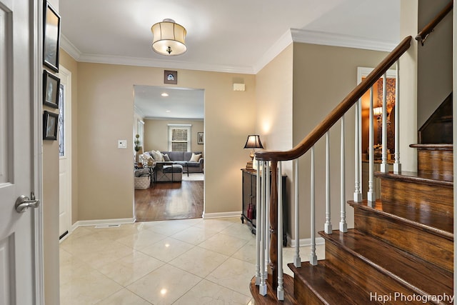 entrance foyer featuring light tile patterned floors and ornamental molding