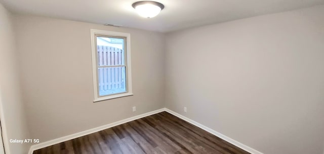 unfurnished room featuring dark hardwood / wood-style floors