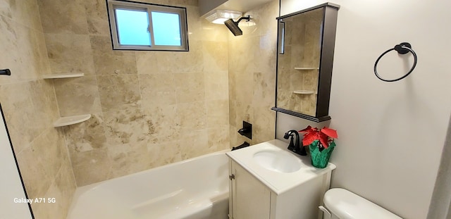 full bathroom with tiled shower / bath, vanity, and toilet