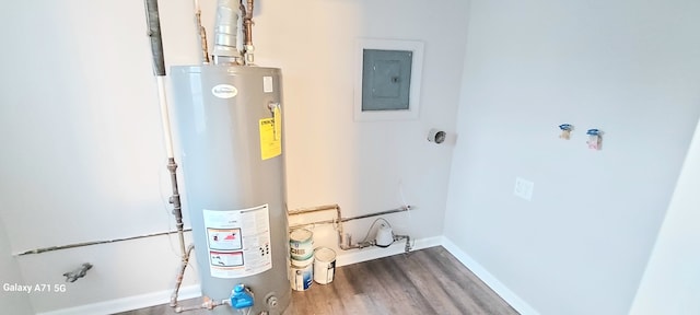 utility room featuring electric panel and water heater