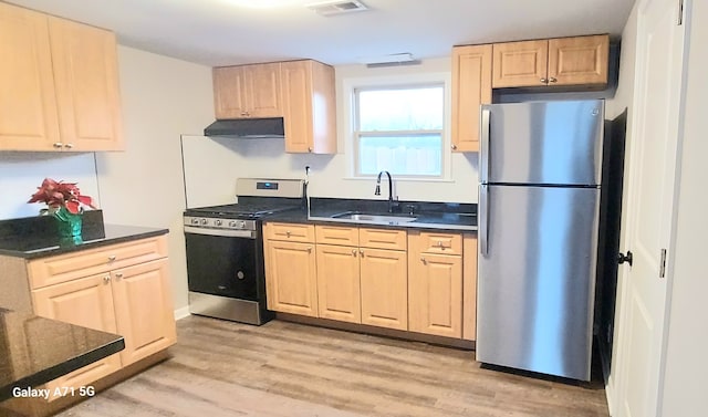 kitchen featuring appliances with stainless steel finishes, light brown cabinetry, extractor fan, sink, and light hardwood / wood-style flooring