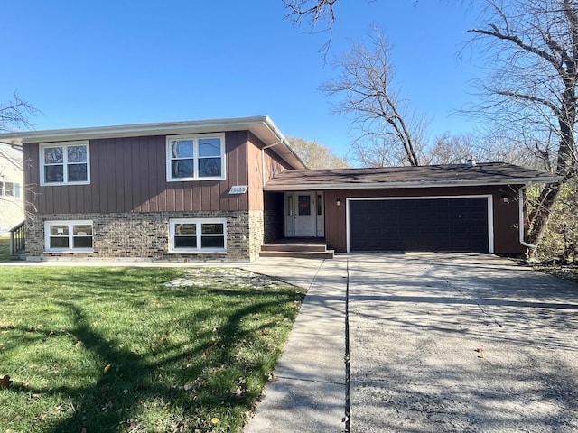 split level home featuring a garage and a front lawn