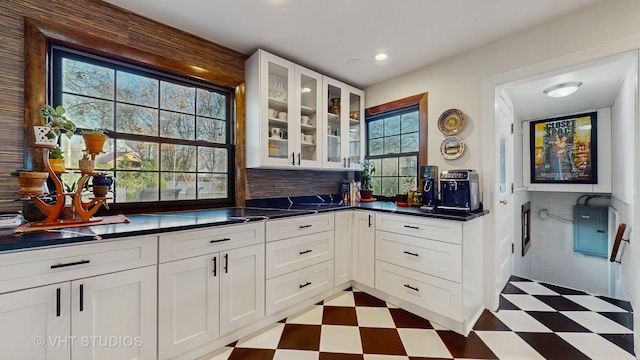 kitchen featuring white cabinetry, decorative backsplash, and a wealth of natural light