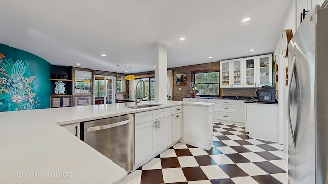 kitchen featuring white cabinets, backsplash, sink, and stainless steel appliances