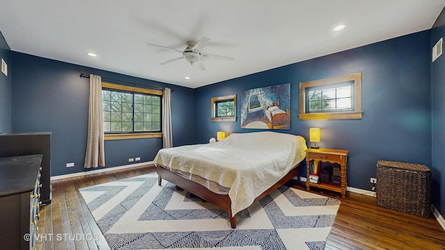 bedroom with ceiling fan and dark wood-type flooring