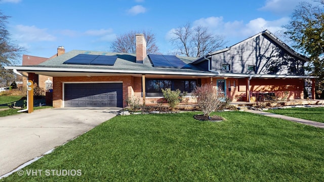 view of front facade featuring a garage, a front yard, and solar panels