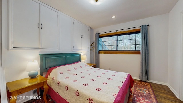 bedroom with dark wood-type flooring