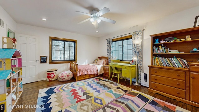 bedroom with dark hardwood / wood-style flooring and ceiling fan